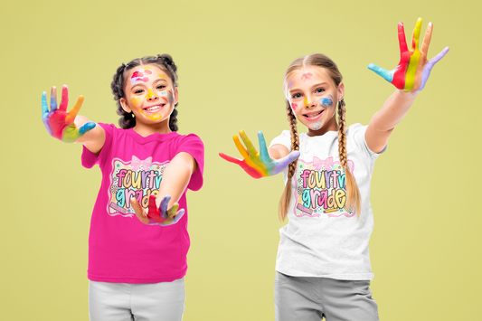Two children with paint on their hands and faces, wearing colorful t-shirts against a light green background.
